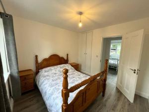 a bedroom with a wooden bed with a wooden floor at Pat's Cottage in Cloone
