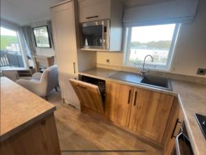 a kitchen with a sink and a counter at 2-6 guests Holiday Chalet in Durdle Door in West Lulworth