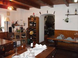 a dining room with a table with a bottle of wine at Grotto Pergola in Giornico
