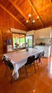 a kitchen with a large white table in a room at Casa lican Ray vista al lago in Licán Ray