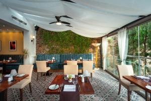 a restaurant with tables and chairs and a large window at Hotel Savoy in Saint Helier Jersey