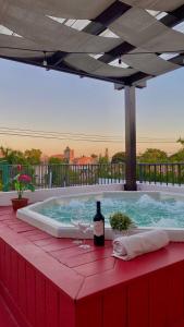 a hot tub with a bottle of wine on a table at Heritage Residences Santo Domingo in Santo Domingo