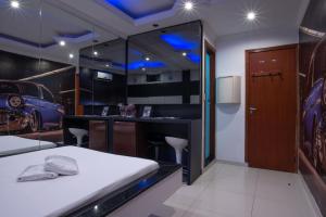 a room with a car garage with a bed and a bar at Motel Fantasy 2 (Adult Only) in Contagem