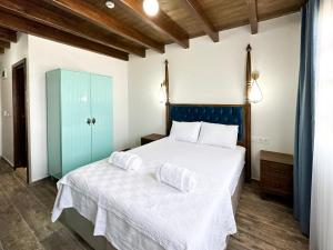 a bedroom with a bed with two pillows on it at İLİA BUTİK OTEL in Eceabat