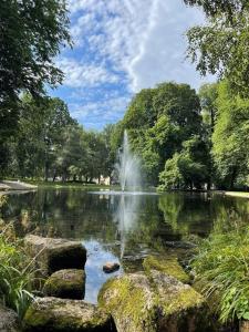 a fountain in the middle of a pond in a park at Fancy apartment by Royal Palace in Oslo