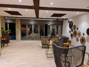 a lobby with chairs and tables in a building at Serenity Terraces Beach, Hotel - Kokrobite in Kokrobite