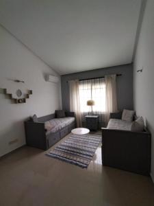 a living room with two couches and a window at villa star hill Tanger in Tangier