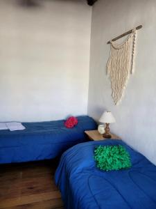 two beds with blue sheets in a room at Pindó I in Concordia