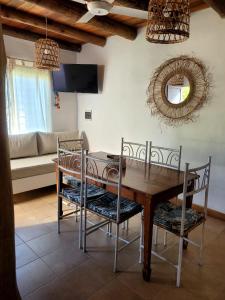 a dining room with a wooden table and chairs at Pindó I in Concordia +8 photos