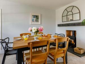 a dining room with a wooden table and chairs at 3 Bed in Budleigh Salterton 88004 in Otterton