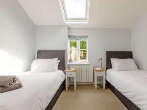 two beds sitting next to each other in a room at 3 Bed in Budleigh Salterton 88004 in Otterton