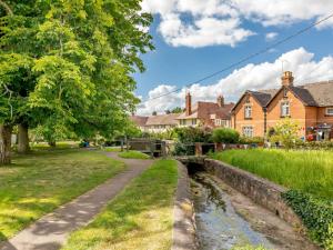 a canal in a village with houses at 3 Bed in Budleigh Salterton 88004 in Otterton