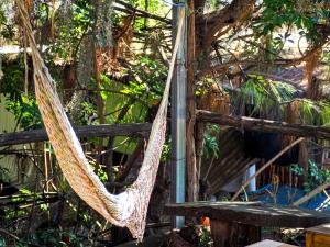 a hammock hanging from a fence in a garden at Hotel San Francisco in San Pedro La Laguna