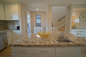 a kitchen with a sink and a counter top at Steps from the Sand-Rooftop Spa-Incredible Views in Newport Beach