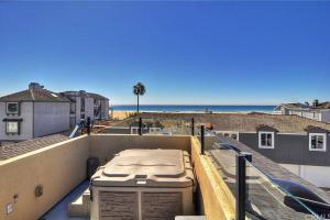 a view of the beach from the balcony of a house at Steps from the Sand-Rooftop Spa-Incredible Views in Newport Beach