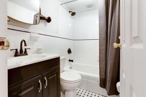 a bathroom with a sink and a toilet and a tub at Apartment 129: Upper East Side in New York