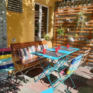 a table and chairs on a patio with a bench at Hôtel du Cygne in Bevaix