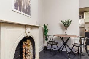 - un salon avec une cheminée et une table dans l'établissement Apartment 332: Hells Kitchen, à New York