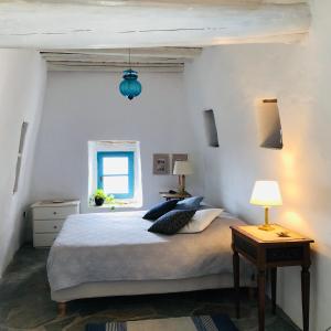 a bedroom with a large bed and a window at Thimari cottage in Andros in Agios Petros