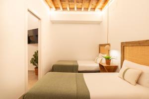 A bed or beds in a room at Lazcano & old town by ELE Apartments