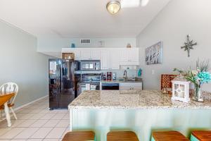 a kitchen with a counter and a refrigerator at Royal Garden Resort #1514 in Myrtle Beach
