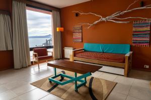 a living room with a couch and a table at Belgrano Decks II in San Carlos de Bariloche