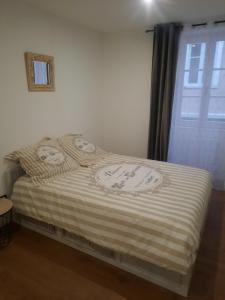 una cama con almohadas de hola kitty encima en Le refuge du bonheur, en Trévoux