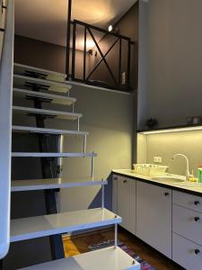 a kitchen with a spiral staircase in the ceiling at Rabarbar in Łódź