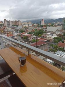 a cup sitting on a wooden table on a balcony at Los Juncos Jujuy in San Salvador de Jujuy
