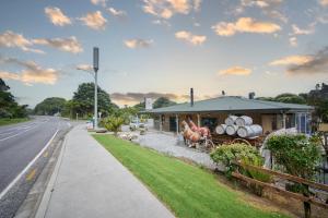 普納凱基的住宿－Punakaiki Rocks Hotel & Garden Bar，前方有马雕的路边建筑