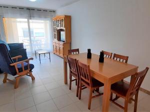a dining room with a wooden table and chairs at Apartamento Llançà, 2 dormitorios, 5 personas - ES-170-34 in Llança