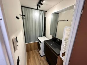 a small bathroom with a sink and a mirror at Studio Corrençon-en-Vercors, 1 pièce, 4 personnes - FR-1-515-204 in Corrençon-en-Vercors