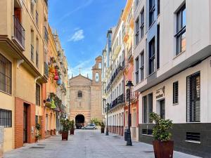 a city street with buildings and a car in the distance at Picú Home in Málaga