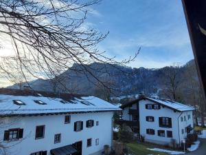 a view of two buildings with snow covered roofs at Ferienwohnung Haus Kampenwand Löhr in Aschau im Chiemgau