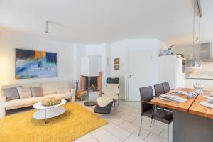 a living room with a couch and a table at Salzwiesen-Lodge in Westereck