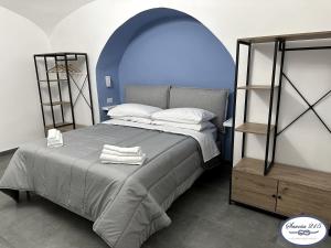 a bedroom with a large bed with an arched ceiling at Savoia 215 - Azzurra Guest House - Napoli in Naples
