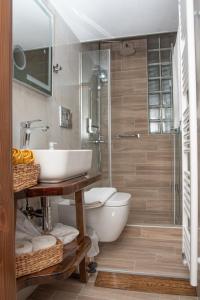 a bathroom with a sink and a toilet and a shower at Serenity by Elite Dwellings in Portariá