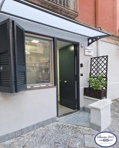 a front door of a store with a green door at Savoia 215 - Azzurra Guest House - Napoli in Naples
