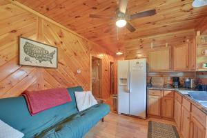 a living room with a couch and a refrigerator at Pet-Friendly Cabin with Hot Tub in Daniel Boone NF in Beattyville