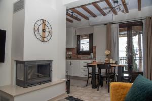 a living room with a fireplace and a table with chairs at Serenity by Elite Dwellings in Portaria