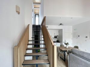 a staircase leading up to a living room and a kitchen at Picú Home in Málaga