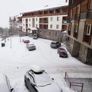 a parking lot with cars covered in snow at axis in Kʼumlistsʼikhe