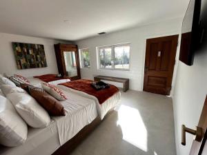 a large bedroom with two beds and a window at Private Hacienda with Heated Pool and Spa with Amazing Views in Del Mar