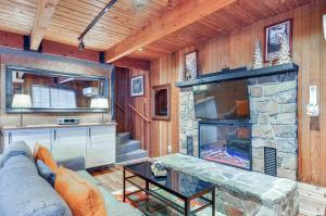 a living room with a fireplace and a couch at Inviting Mt Hood Cabin with Porch 1 Mi to Skibowl! in Government Camp