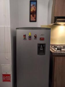 a refrigerator in a kitchen with magnets on it at Beatiful apartment in condo in Girardot