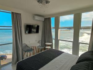 Cama ou camas em um quarto em Grand Hotel Guarujá - A sua Melhor Experiência Beira Mar na Praia!