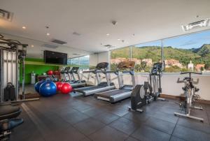 a gym with cardio equipment and a large window at Hampton by Hilton Bogota Usaquen in Bogotá