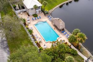 an overhead view of a swimming pool with chairs and a house at Condo in Naples Near Mercato and Close to Vanderbilt Beach in Naples