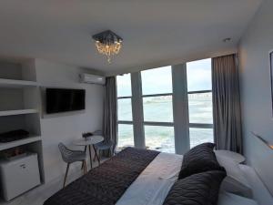 Cama ou camas em um quarto em Grand Hotel Guarujá - A sua Melhor Experiência Beira Mar na Praia!