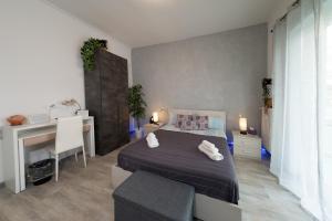 a bedroom with a bed and a desk and a desk at Relax room Apartment in Rome